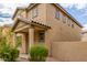 Tan two-story house with a small front yard and landscaping at 915 E Agua Fria Ln, Avondale, AZ 85323