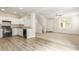 Modern kitchen with white cabinets, black appliances, and hardwood floors at 915 E Agua Fria Ln, Avondale, AZ 85323