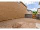 Small backyard with gravel, a block wall, and a gate for access at 915 E Agua Fria Ln, Avondale, AZ 85323