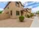 Two story tan house with landscaping and a walkway at 915 E Agua Fria Ln, Avondale, AZ 85323