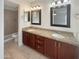 Bathroom with double vanity, granite countertop, and shower at 20446 N 37Th Ln, Glendale, AZ 85308