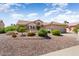 Single story home exterior with attractive landscaping and desert plants at 16121 W Silver Falls Dr, Surprise, AZ 85374