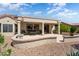Spacious backyard patio with seating and a desert landscape at 16121 W Silver Falls Dr, Surprise, AZ 85374