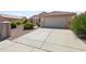 Single-story home with a two-car garage and desert landscaping at 16121 W Silver Falls Dr, Surprise, AZ 85374