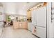 Kitchen features white appliances and a large refrigerator at 16121 W Silver Falls Dr, Surprise, AZ 85374