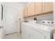 Laundry room with washer, dryer, and additional storage at 16121 W Silver Falls Dr, Surprise, AZ 85374