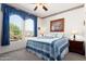 Cozy bedroom with a queen-size bed and a ceiling fan at 16121 W Silver Falls Dr, Surprise, AZ 85374