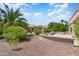 Spacious backyard with desert landscaping and a covered patio at 16121 W Silver Falls Dr, Surprise, AZ 85374