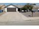 House exterior featuring a two-car garage and well-maintained landscaping at 10232 W Campbell Ave, Phoenix, AZ 85037