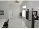 View of kitchen with stainless steel refrigerator and white cabinetry at 10232 W Campbell Ave, Phoenix, AZ 85037