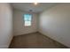 Simple bedroom with carpeted floor, window with blinds, and neutral walls at 47789 W Moeller Rd, Maricopa, AZ 85139