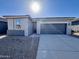 New single-story home with gray exterior, two-car garage, and desert landscaping at 47789 W Moeller Rd, Maricopa, AZ 85139