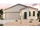 Modern home with a beige exterior and green front door at 24553 W Hopi St, Buckeye, AZ 85326
