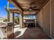 Covered patio with hot tub, built-in grill, and seating area at 25024 S Stoney Lake Dr, Sun Lakes, AZ 85248