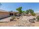 Landscaped backyard with stone pathway and outdoor fireplace at 4730 E Desert Forest Trl, Cave Creek, AZ 85331