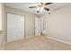 Bedroom with ceiling fan, double-door closet, and access to hallway at 4730 E Desert Forest Trl, Cave Creek, AZ 85331