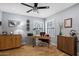 Home office with wood desk, cabinet and window with plantation shutters at 8300 E Vía De Ventura Blvd # 1015, Scottsdale, AZ 85258