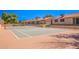 Community tennis court with brown surface and net at 1021 S Greenfield Rd # 1080, Mesa, AZ 85206