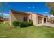 Tan stucco house with arched window and attached garage at 1021 S Greenfield Rd # 1080, Mesa, AZ 85206