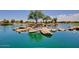 Peaceful lake with a small island and rocks at 42531 W Heavenly Pl, Maricopa, AZ 85138