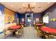 Game room with multiple game tables and seating at 42531 W Heavenly Pl, Maricopa, AZ 85138