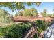 Footbridge over waterway with lush landscaping at 42531 W Heavenly Pl, Maricopa, AZ 85138