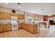 Open kitchen with wood cabinets, granite countertops, and view into adjacent living area at 917 W Desert Hills Estate Dr, Phoenix, AZ 85086