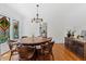 Round dining table with stained glass windows and kitchen view at 73 W Lewis Ave, Phoenix, AZ 85003