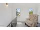 Upstairs sitting area with a comfy chair and natural light at 73 W Lewis Ave, Phoenix, AZ 85003