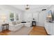 Bright living room with white couch and hardwood floors at 73 W Lewis Ave, Phoenix, AZ 85003