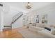 Living room with hardwood floors, white couch and staircase at 73 W Lewis Ave, Phoenix, AZ 85003