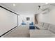 Finished basement with a large screen and sectional sofa at 73 W Lewis Ave, Phoenix, AZ 85003