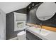 Chic bathroom with dark gray walls, a round mirror, and floating vanity at 73 W Lewis Ave, Phoenix, AZ 85003