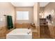 Relaxing bathroom with a large soaking tub and tile surround at 2104 E 36Th Ave, Apache Junction, AZ 85119