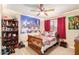 bedroom with full-size bed, bookcase, and city-themed wall tapestry at 2104 E 36Th Ave, Apache Junction, AZ 85119