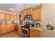 Kitchen with wood cabinets, granite countertops and microwave at 2104 E 36Th Ave, Apache Junction, AZ 85119