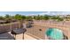 Patio with table and chairs, overlooking a backyard pool and neighborhood at 2104 E 36Th Ave, Apache Junction, AZ 85119