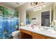 Clean bathroom with wood vanity, toilet, and underwater-themed shower curtain at 2104 E 36Th Ave, Apache Junction, AZ 85119
