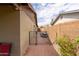 Side yard access with a gate, brick pathway, and small storage area at 5119 W Onyx Ave, Glendale, AZ 85302