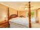 Main bedroom with wood post bed and backyard access at 5119 W Onyx Ave, Glendale, AZ 85302