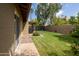 Landscaped backyard with grassy area and patio at 5119 W Onyx Ave, Glendale, AZ 85302