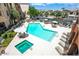 Complex pool and spa with surrounding patio furniture at 14575 W Mountain View Blvd # 221, Surprise, AZ 85374