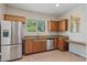 Kitchen with stainless steel appliances and wood cabinets at 14575 W Mountain View Blvd # 221, Surprise, AZ 85374