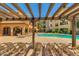 Inviting pool area with lounge chairs and a pergola at 14575 W Mountain View Blvd # 221, Surprise, AZ 85374