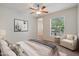 Bright bedroom with ceiling fan and sitting area at 14575 W Mountain View Blvd # 221, Surprise, AZ 85374