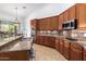 Island kitchen with granite countertops, stainless steel appliances, and double sink at 9845 E Inglewood St, Mesa, AZ 85207