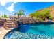 Stunning pool with a cascading waterfall feature at 9845 E Inglewood St, Mesa, AZ 85207
