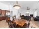 Open concept kitchen and living area with breakfast bar and fireplace at 9845 E Inglewood St, Mesa, AZ 85207
