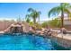Relaxing pool area with a waterslide and waterfall feature at 9845 E Inglewood St, Mesa, AZ 85207