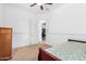 Spacious bedroom with a view into another room and a ceiling fan at 9845 E Inglewood St, Mesa, AZ 85207